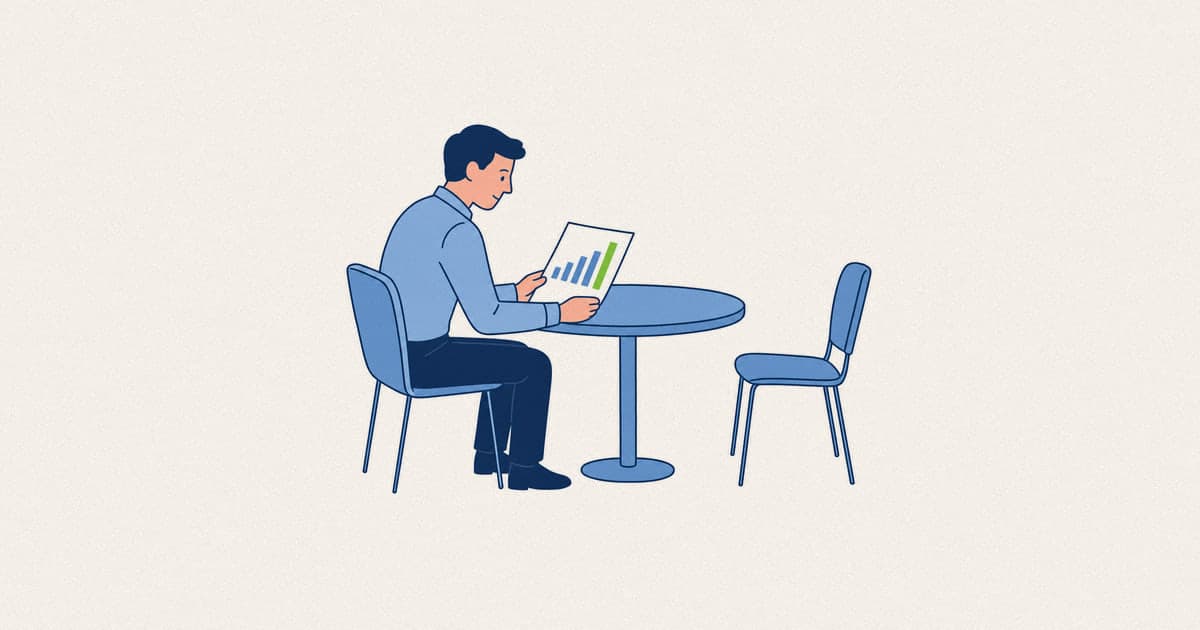 A manager reviewing a chart of rising costs beside an empty chair, the cost of employee turnover